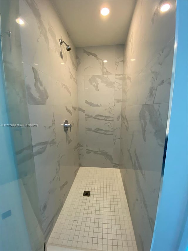 bathroom with a tile shower