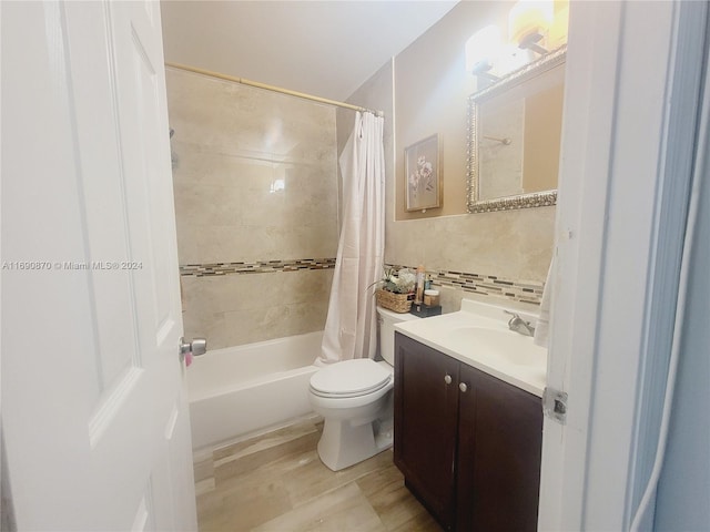 full bathroom with vanity, toilet, backsplash, and shower / tub combo