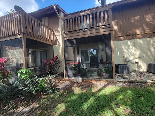 back of property featuring a balcony and central air condition unit