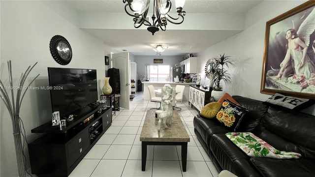 tiled living room featuring a chandelier and a textured ceiling