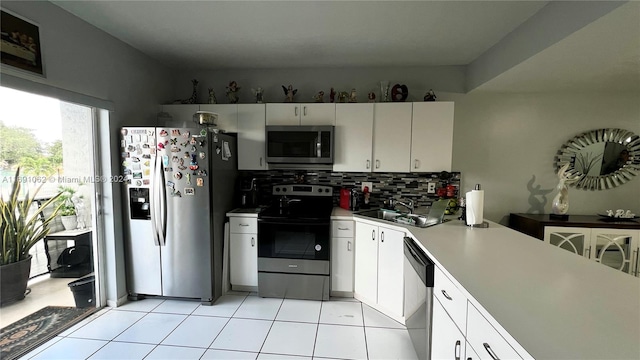 kitchen with white cabinetry, sink, backsplash, and appliances with stainless steel finishes