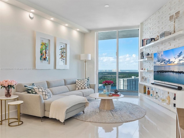 living room with floor to ceiling windows and light tile patterned floors