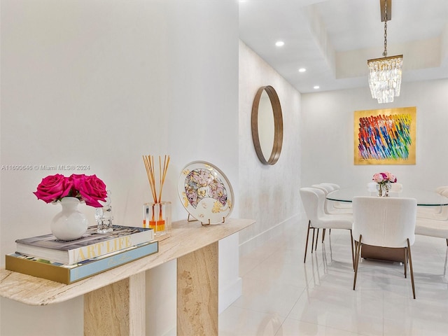 tiled dining space with a notable chandelier