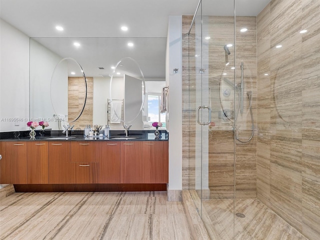 bathroom featuring hardwood / wood-style floors, vanity, and a shower with shower door