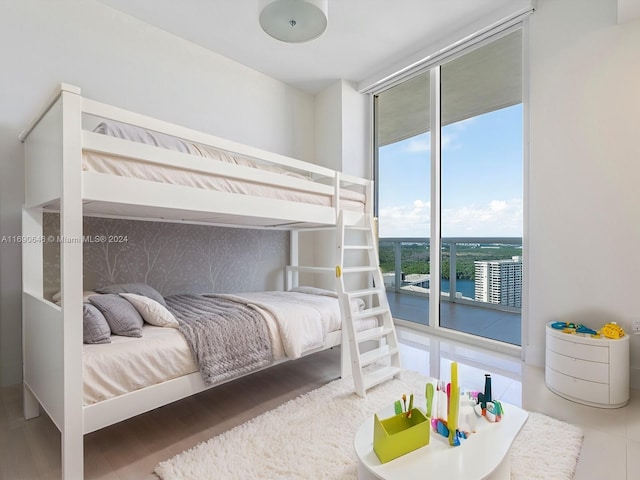 tiled bedroom with access to exterior and expansive windows