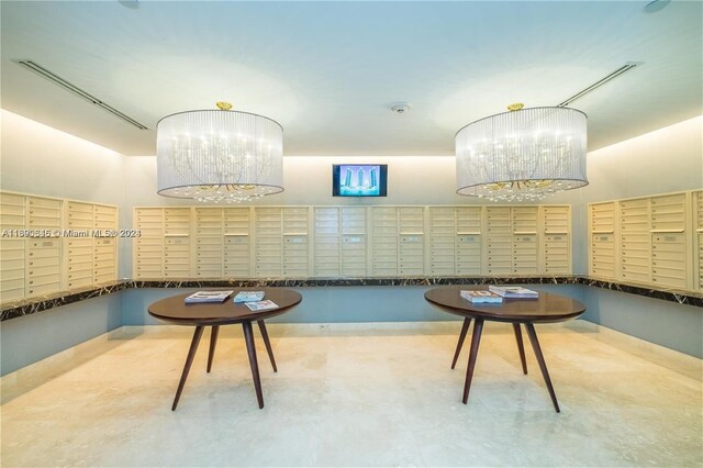 interior space featuring a chandelier and a mail area