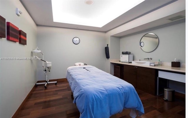 bedroom with dark hardwood / wood-style flooring and sink