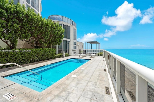 view of swimming pool with a water view