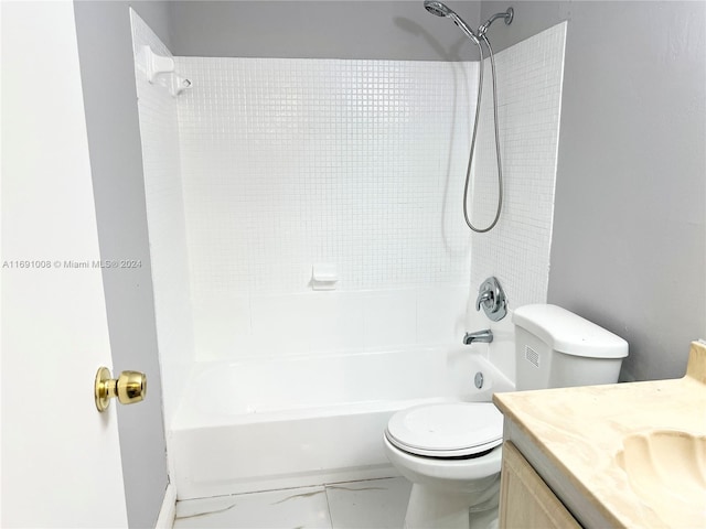 full bathroom with toilet, vanity, and tiled shower / bath