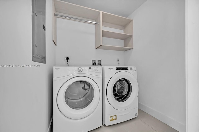 laundry room featuring separate washer and dryer and light tile patterned floors