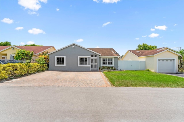 ranch-style home with a garage and a front lawn