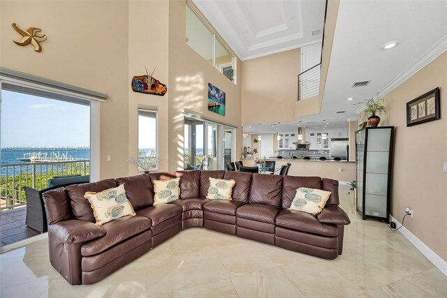 dining area with a high ceiling and crown molding