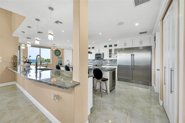 kitchen featuring island range hood, wine cooler, white cabinetry, appliances with stainless steel finishes, and an island with sink