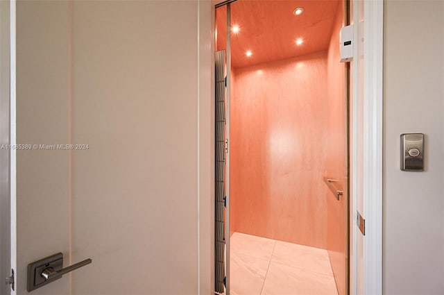 bathroom featuring tile patterned flooring and elevator