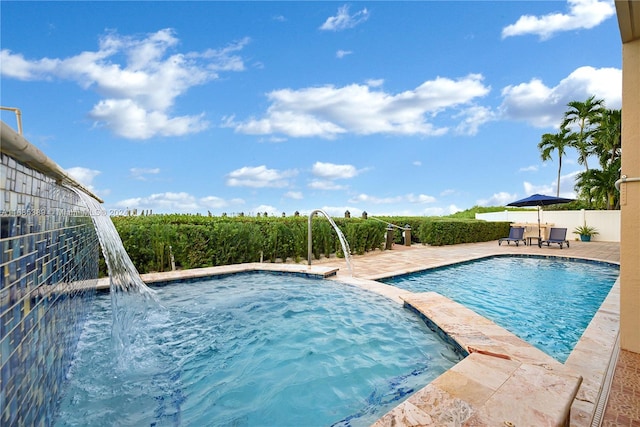 view of swimming pool featuring a patio and pool water feature