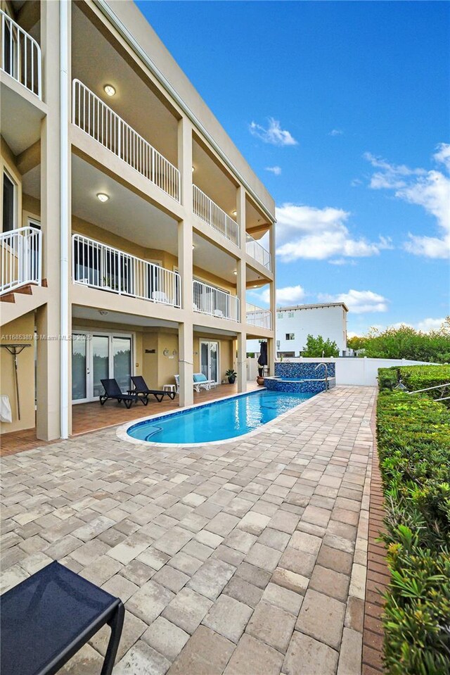 view of pool featuring a patio and a rural view