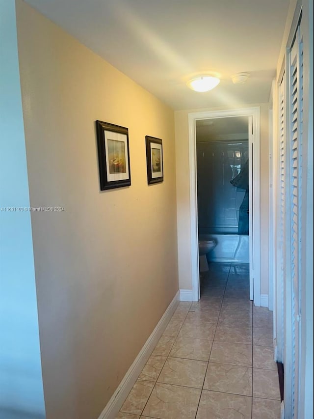 corridor with light tile patterned flooring