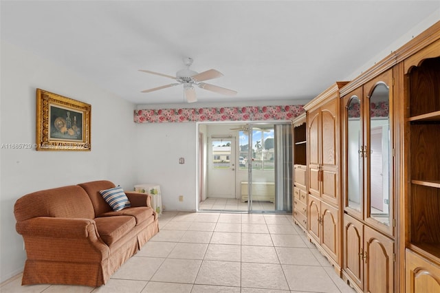 living room with ceiling fan and light tile patterned flooring