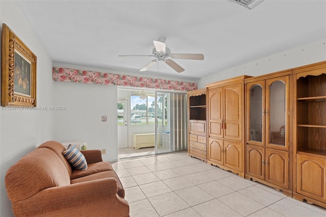 tiled living room featuring ceiling fan