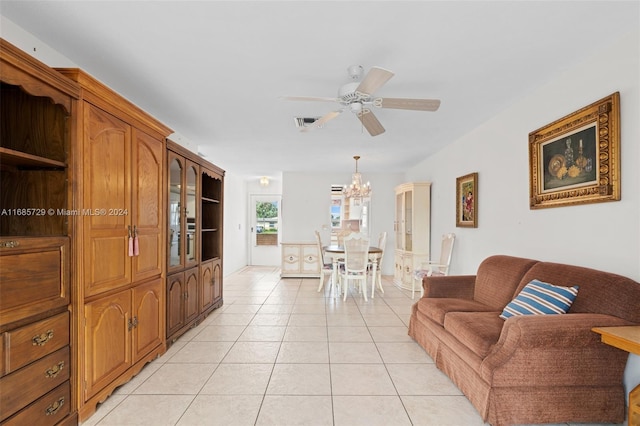 living room with light tile patterned floors and ceiling fan with notable chandelier