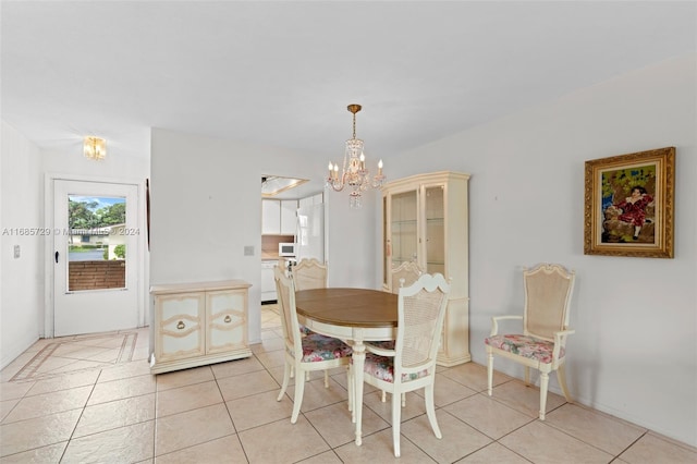 dining space featuring a chandelier and light tile patterned floors