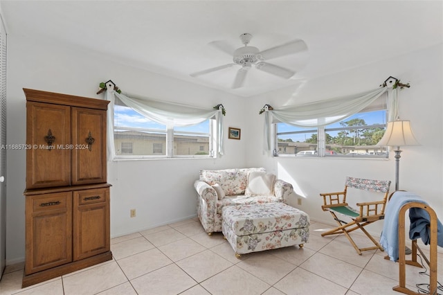 living area featuring ceiling fan and light tile patterned floors