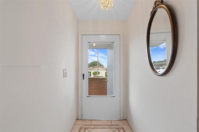 doorway with light tile patterned flooring