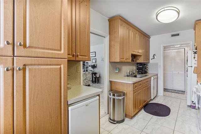 kitchen featuring dishwasher, backsplash, and sink