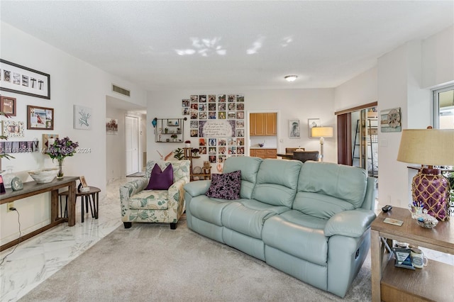 living room with carpet floors and a textured ceiling