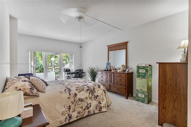 bedroom with a textured ceiling, ceiling fan, access to exterior, and light carpet