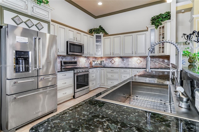 kitchen featuring sink, stainless steel appliances, tasteful backsplash, crown molding, and light tile patterned floors