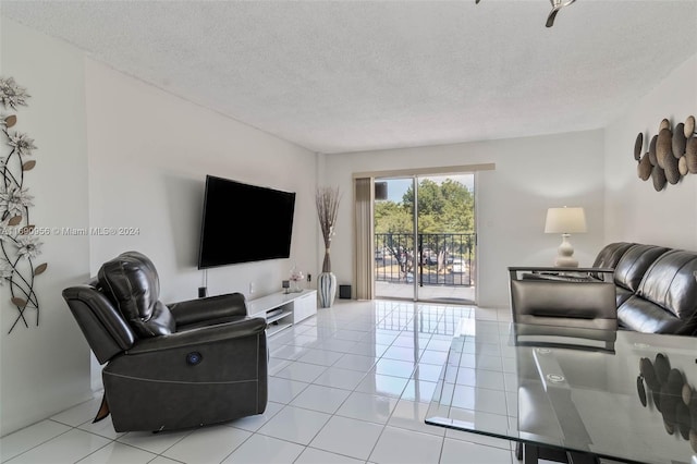 living room featuring a textured ceiling and light tile patterned floors