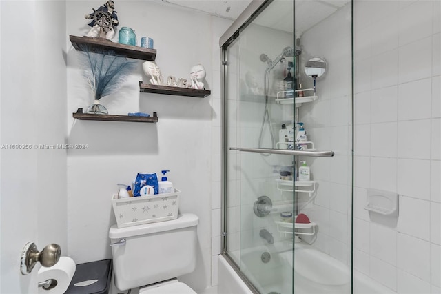 bathroom with shower / bath combination with glass door and toilet