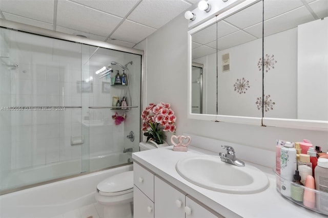 full bathroom featuring toilet, vanity, tile patterned flooring, and shower / bath combination with glass door