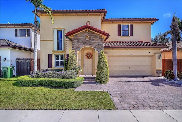 mediterranean / spanish house with a garage and a front lawn