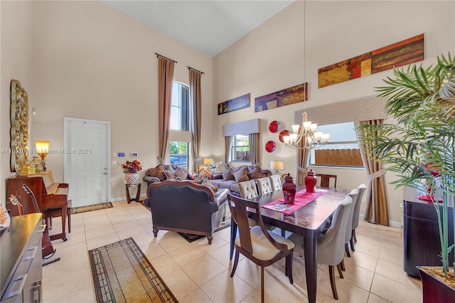 dining area with a high ceiling, light tile patterned floors, and a notable chandelier