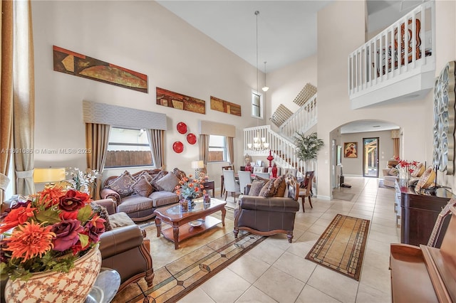 living room featuring a high ceiling and light tile patterned floors