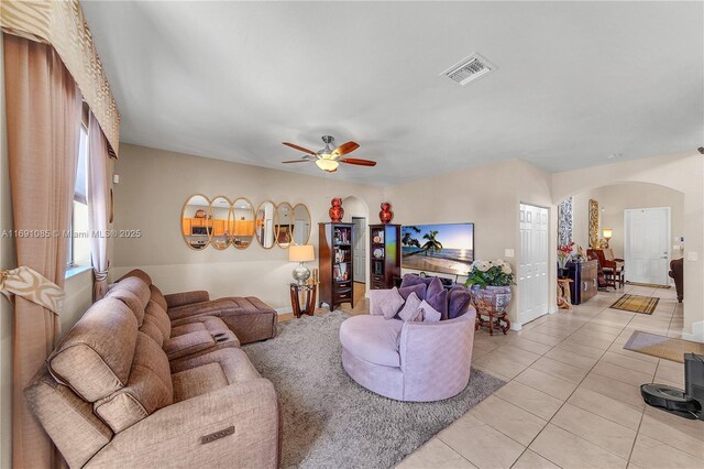 tiled living room featuring ceiling fan