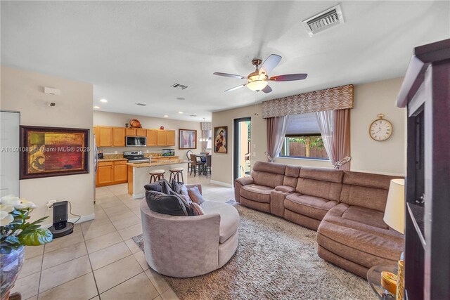 living room with ceiling fan and light tile patterned floors