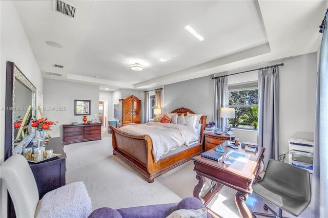 bedroom featuring carpet floors and a tray ceiling