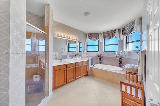 bathroom with vanity, plenty of natural light, tile patterned floors, and separate shower and tub