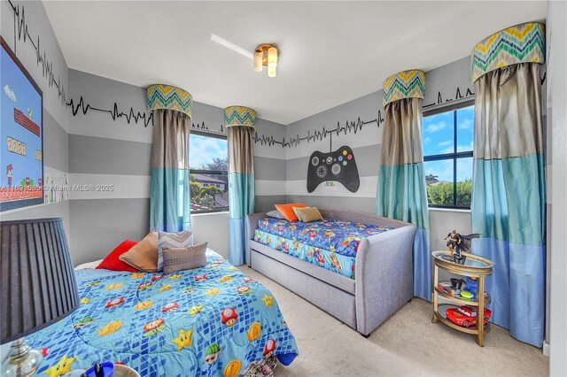 bedroom with carpet floors and multiple windows