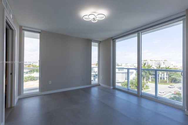 unfurnished room with expansive windows