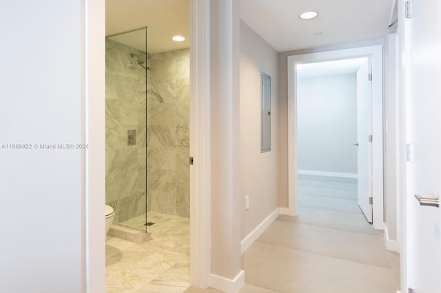 bathroom with toilet and a tile shower