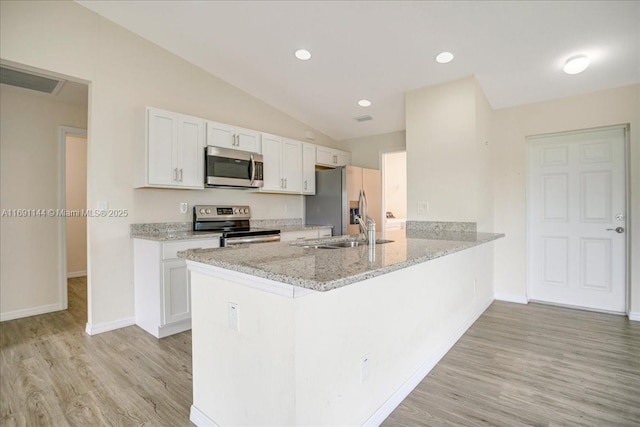 kitchen with white cabinetry, sink, kitchen peninsula, appliances with stainless steel finishes, and light wood-type flooring