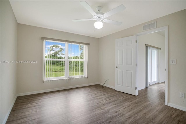 empty room with ceiling fan and wood-type flooring