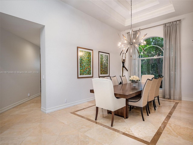 dining area with a raised ceiling, a notable chandelier, and crown molding