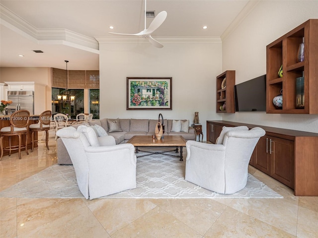 living room featuring ceiling fan with notable chandelier and crown molding