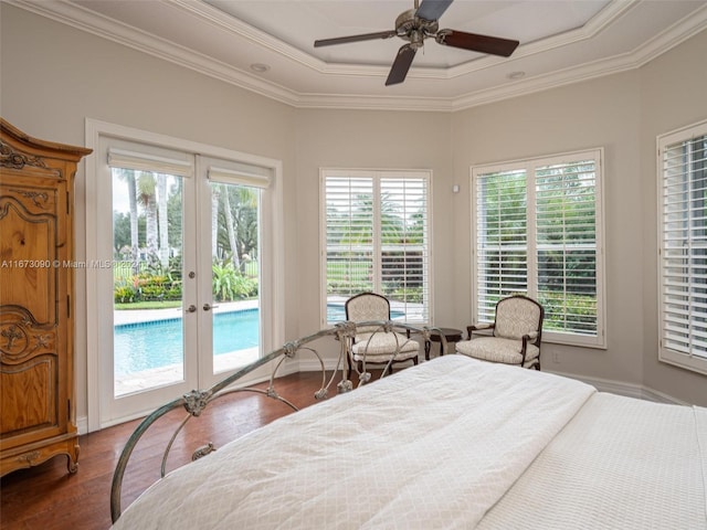 bedroom featuring multiple windows, french doors, hardwood / wood-style flooring, and access to exterior