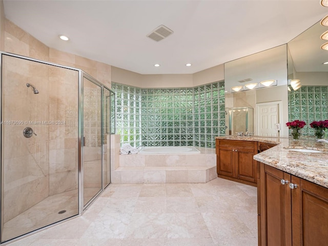 bathroom with vanity and separate shower and tub